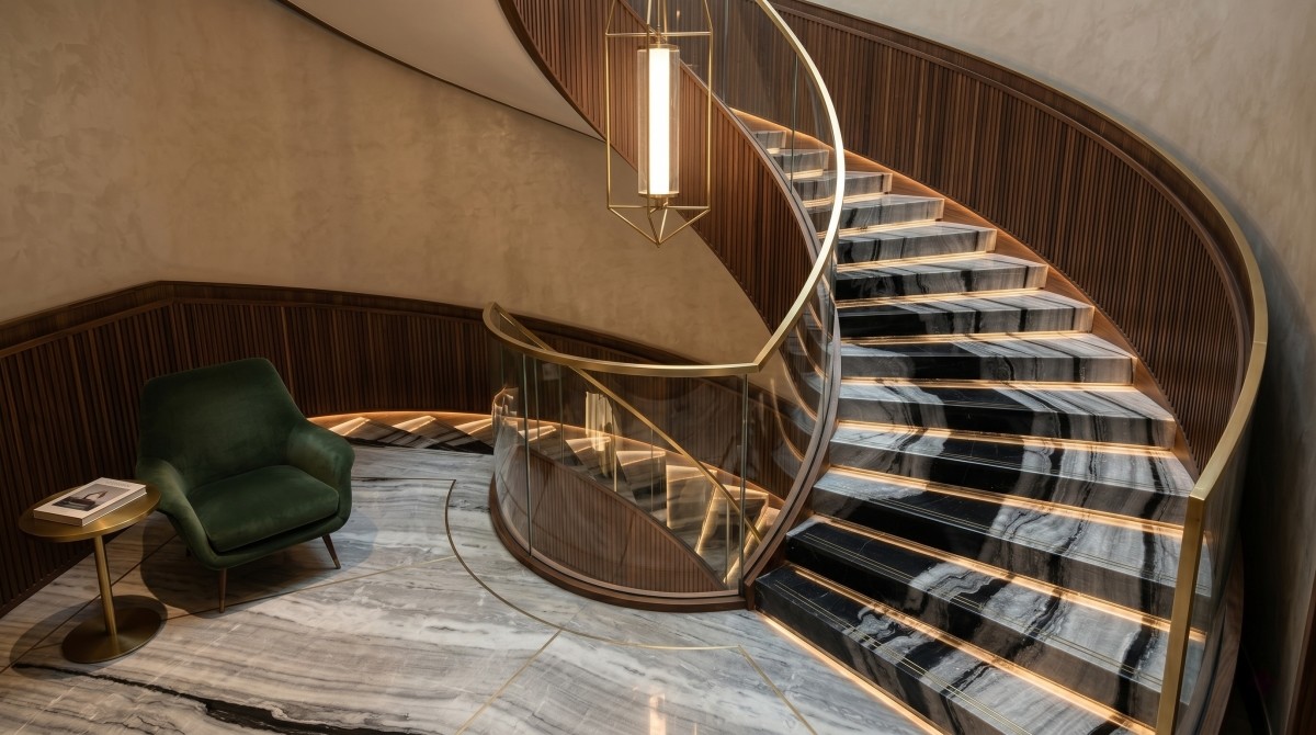 Boutique hotel staircase project featuring bold linear grey black and white marble with custom-cut treads and risers