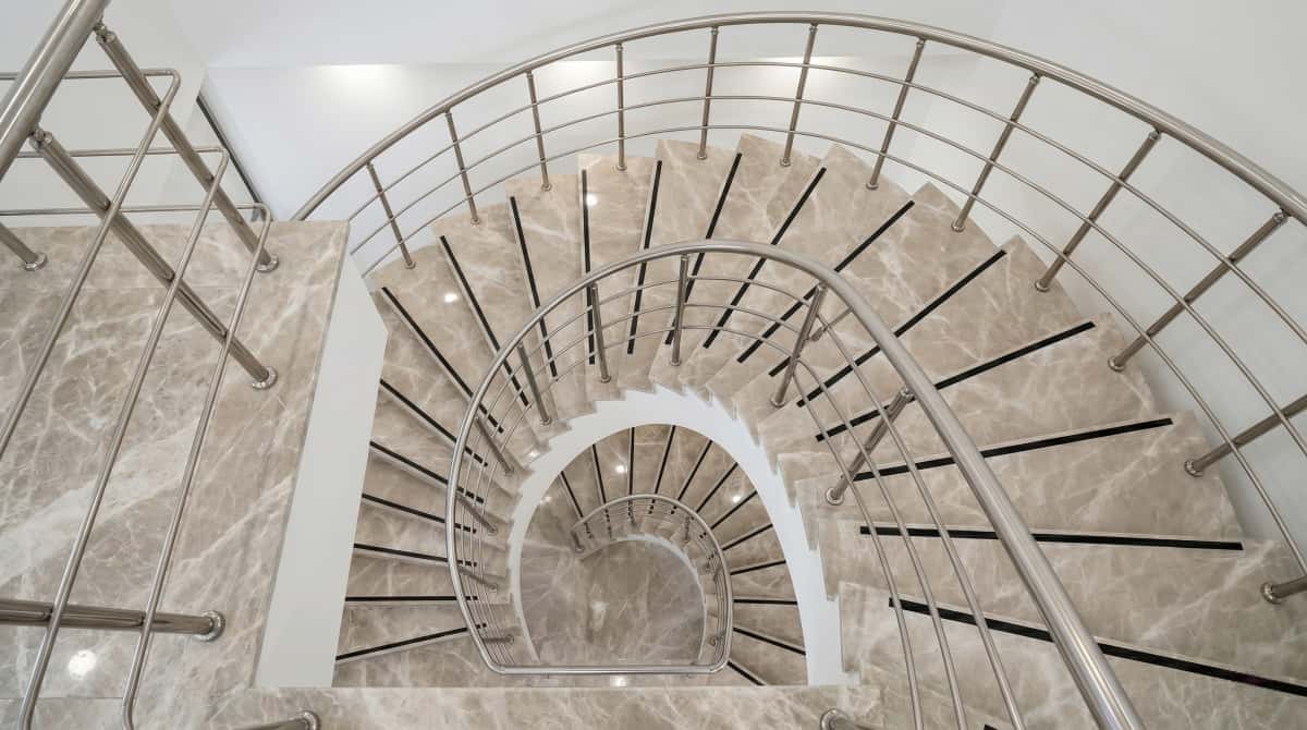 Detailed view of Turkish beige-grey marble stair treads, risers, and side cladding Detailed view of Turkish beige-grey marble stair treads, risers, and side cladding