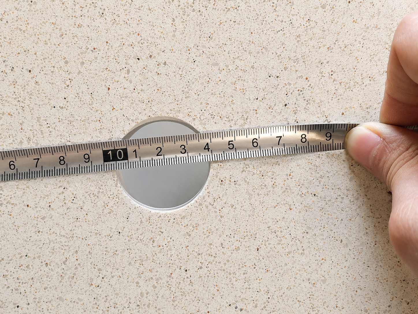 Warm beige quartz countertop with fine speckled texture and polished finish for multifamily bathroom vanity use
