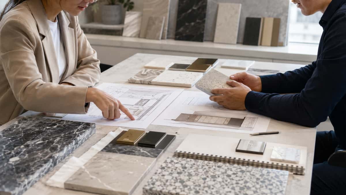 architect-buyer-reviewing-stone-samples-project-areas Architect and buyer reviewing stone samples for different project areas