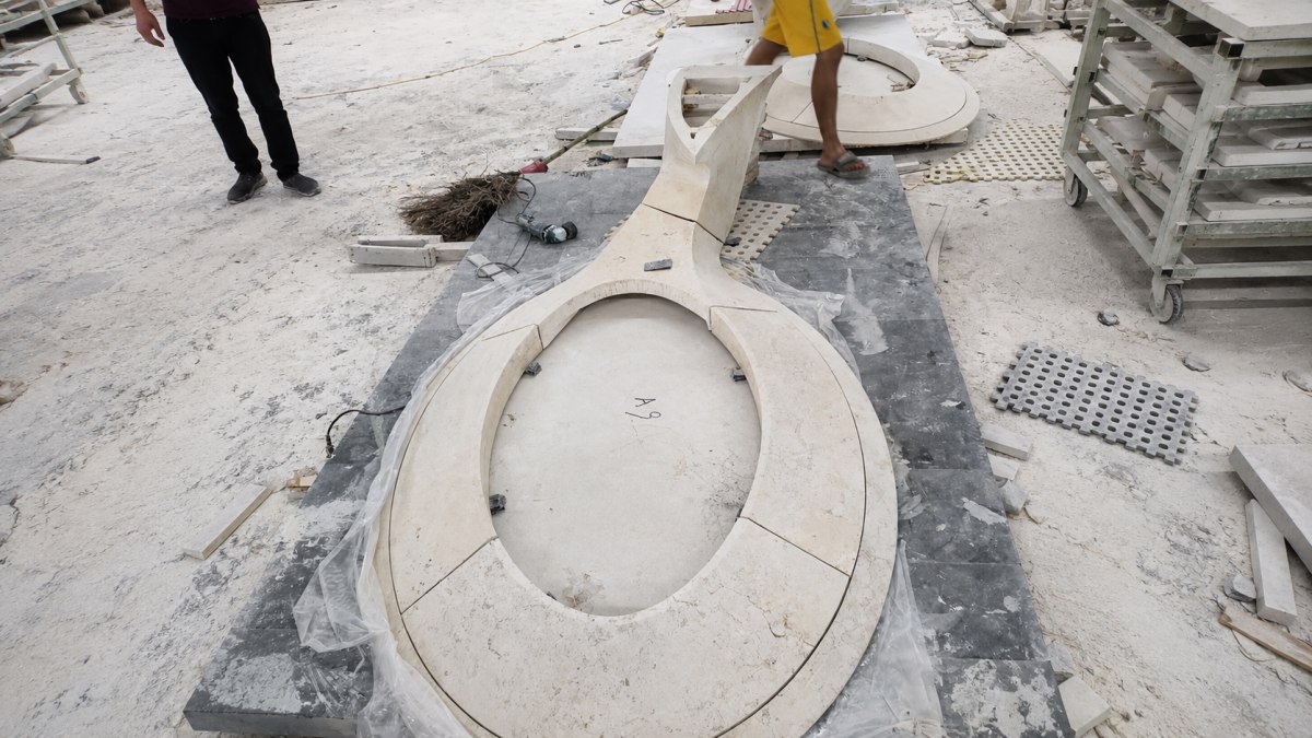 Factory dry-lay assembly of a special-shaped French limestone table
