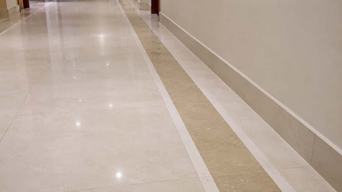 artificial-marble-corridor-border-line-and-skirting Artificial marble corridor flooring with wall border line and matching skirting detail