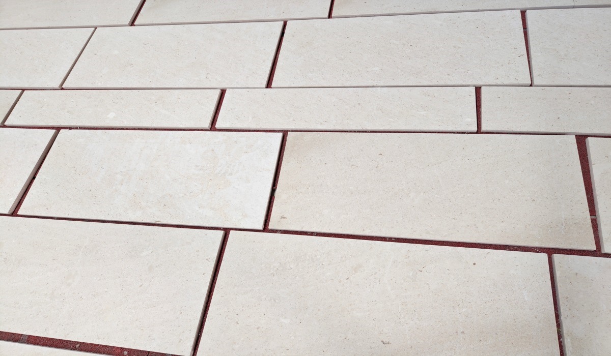 cotswold-cream-limestone-tiles-dry-lay-review Cotswold Cream limestone tiles arranged for dry lay inspection before project packing