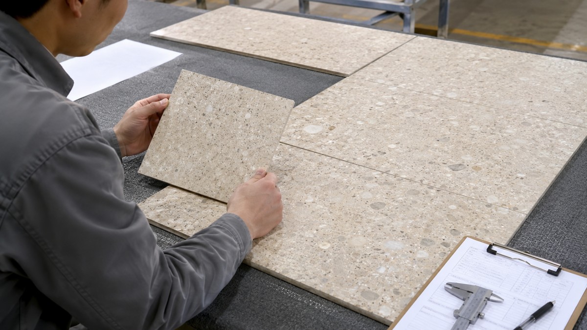 Aoli Stone terrazzo sample compared with finished production pieces during inspection