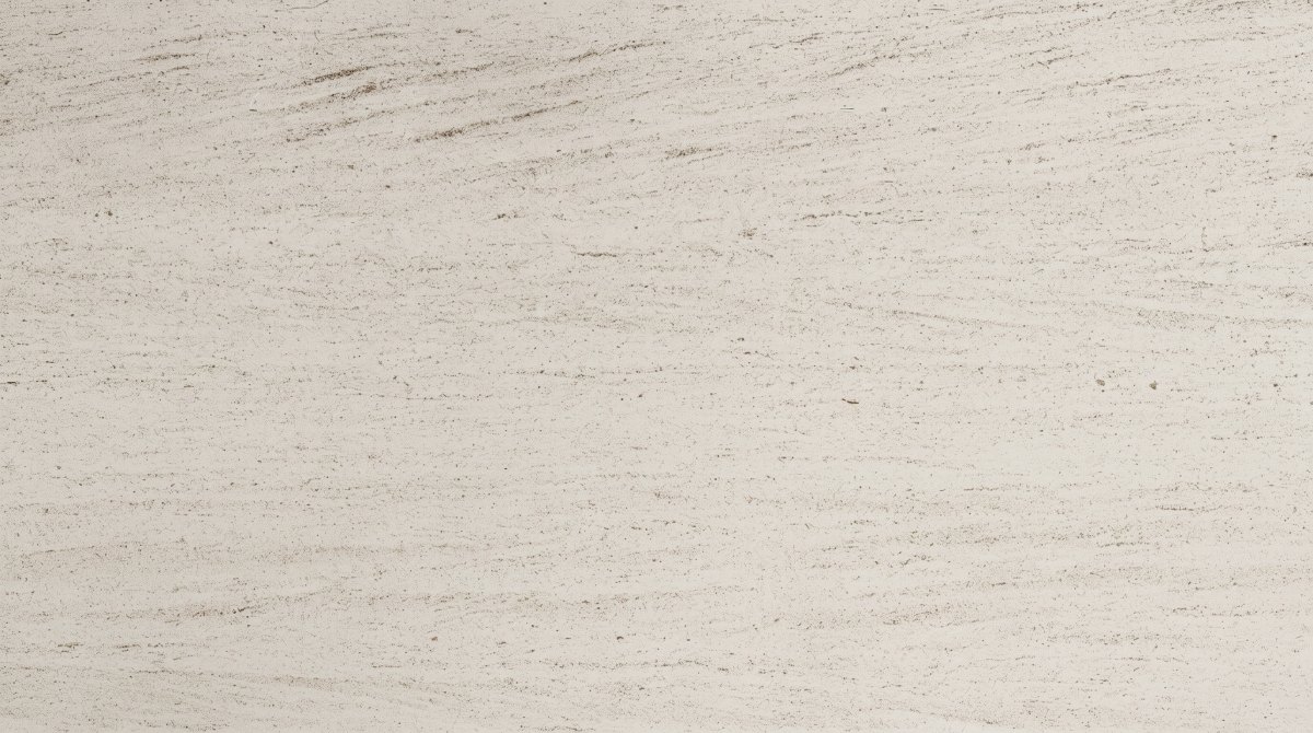  Close-up of pale ivory limestone with fine linear grain, small pores and natural speckles