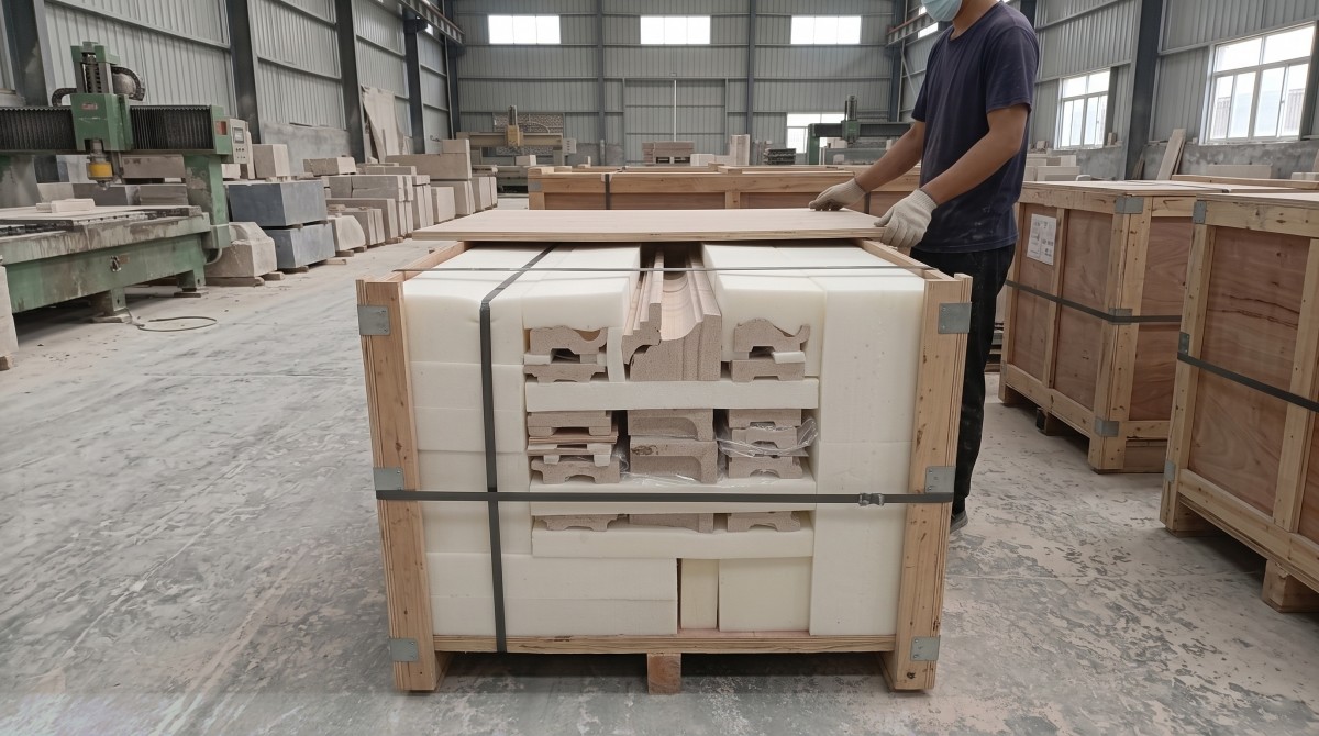 Protected limestone molding and panel pieces packed in an export wooden crate